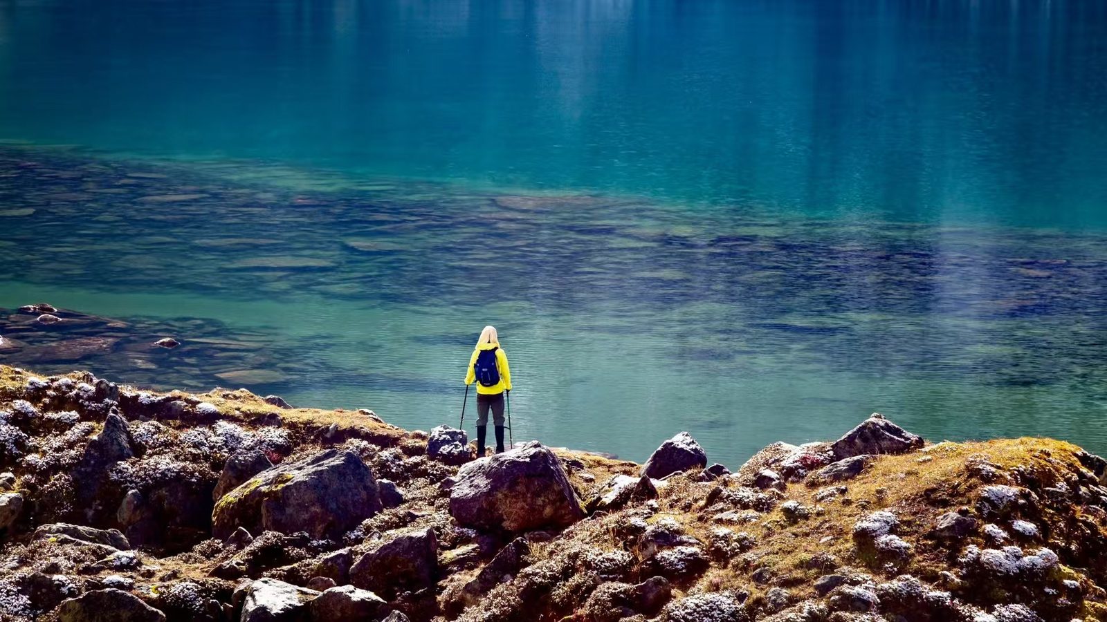 Trekker by a Tibetan high-altitude lake